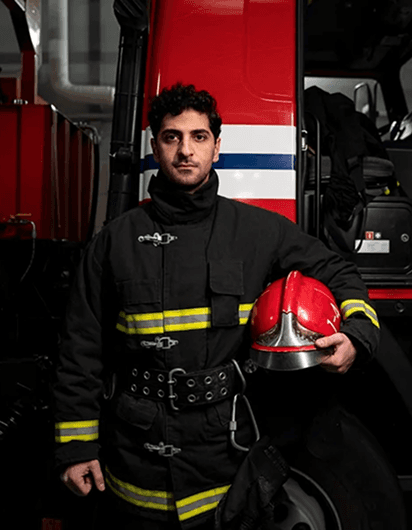 Female firefighter with helmet in fire station