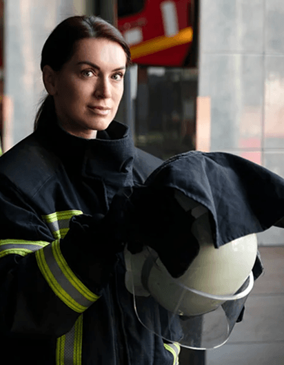 Female firefighter with helmet in uniform